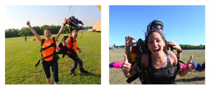 Girls cheer after landing from skydive.