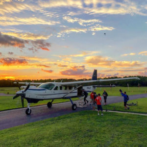 The plane at sunset on the runway.